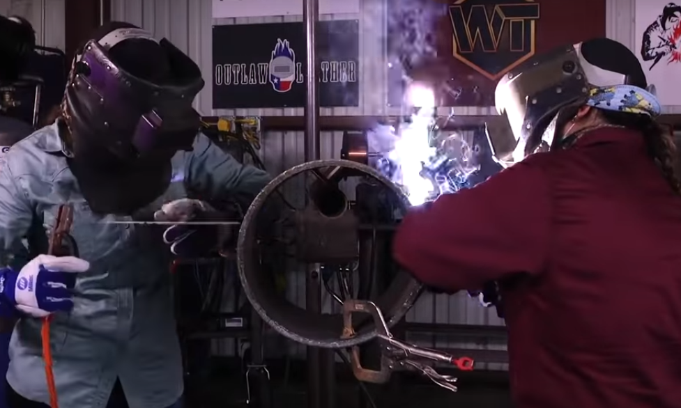 women welding a big pipe